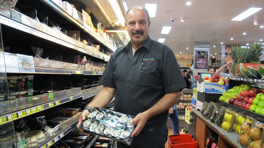 John Fiotakis holds a tray of oysters at the Lipscombe Larder.