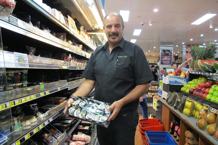 John Fiotakis holds a tray of oysters at the Lipscombe Larder.