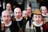 Members of the public wear William Shakespeare masks at a parade in Stratford-upon-Avon.
