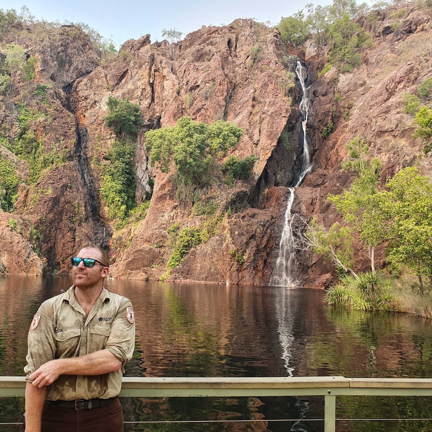 Litchfield Park ranger standing in front of waterfall.