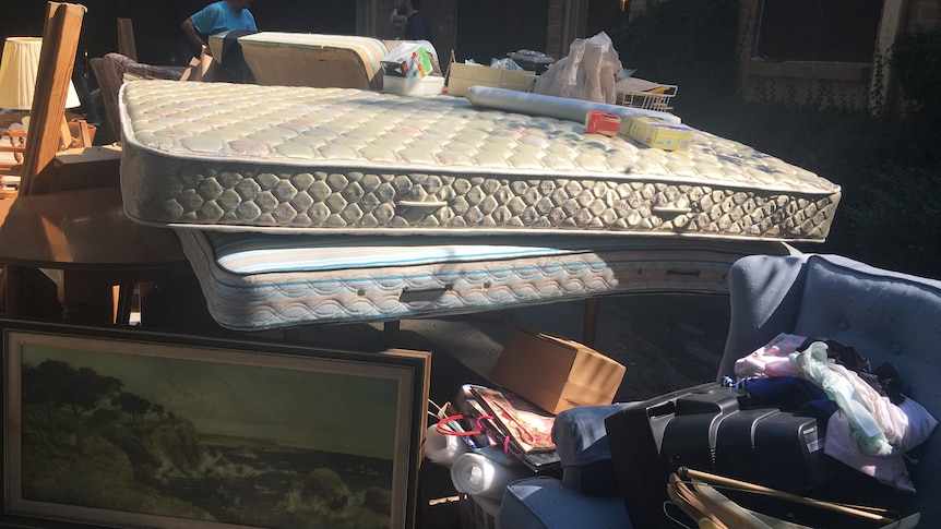 Mattresses and other pieces of ruined furniture litter the outside of the Houston home.