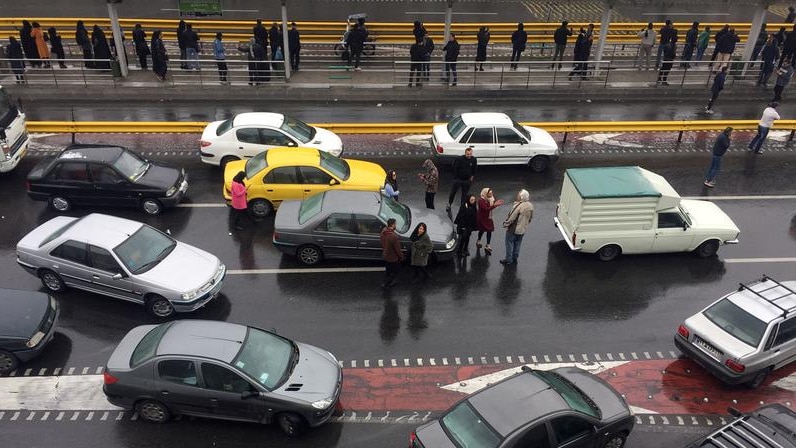 Protesters and cars on a highway.