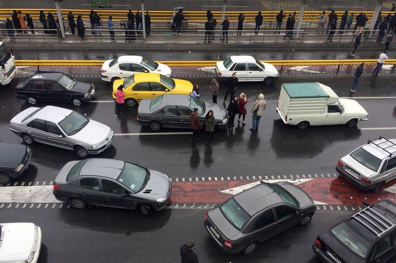 Protesters and cars on a highway.