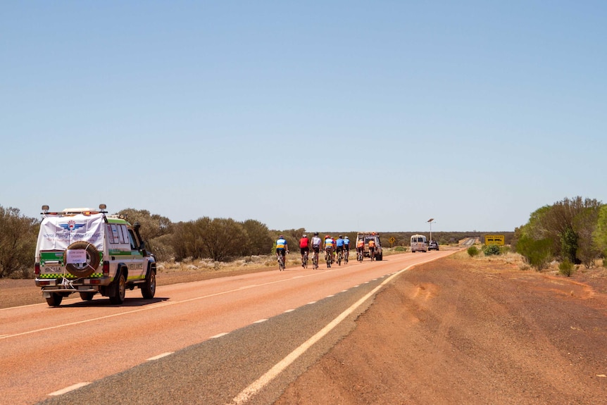 Bike riders on the Goldfields Highway, about 50 kilometres from Laverton.