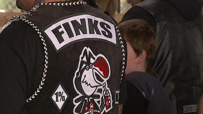 The word Finks is written across a man's jacket.