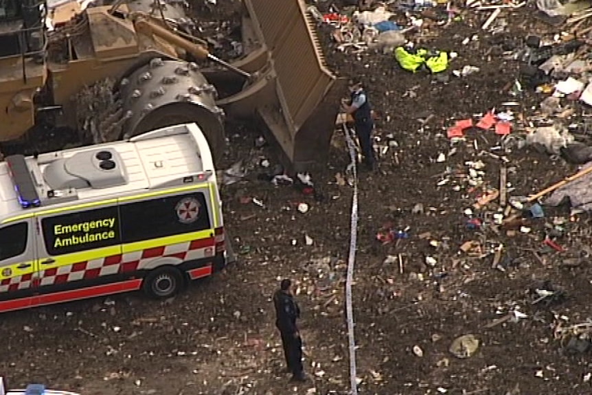 Police set up a crime scene at a waste facility