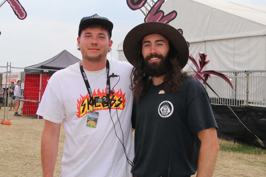 Party in the Paddock festival co-director Ryan Limb and Jesse Higgs standing up the Vibestown production sign