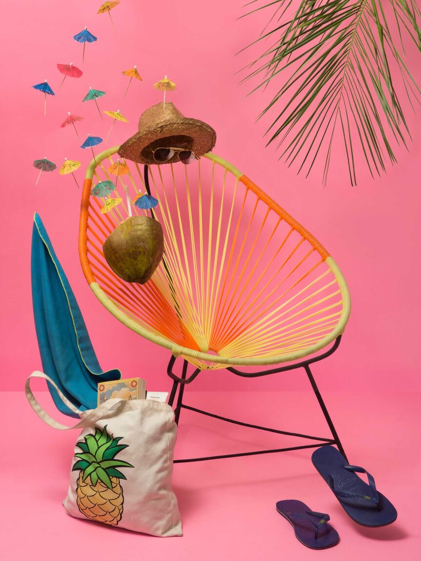 Relaxing summer scene with chair, hat, sunglasses, etc, depicting the importance of rest and recuperation on mental health days.