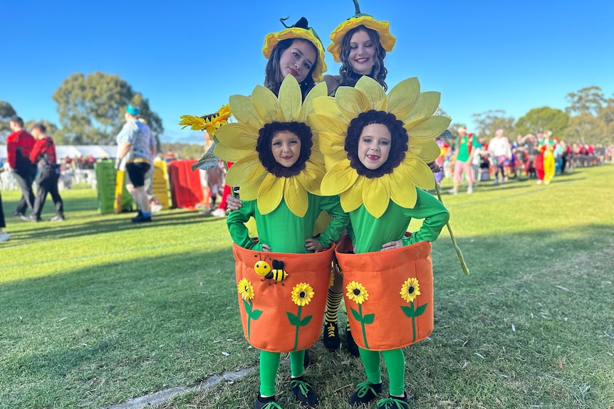 Two adults and two children dressed up as sunflowers