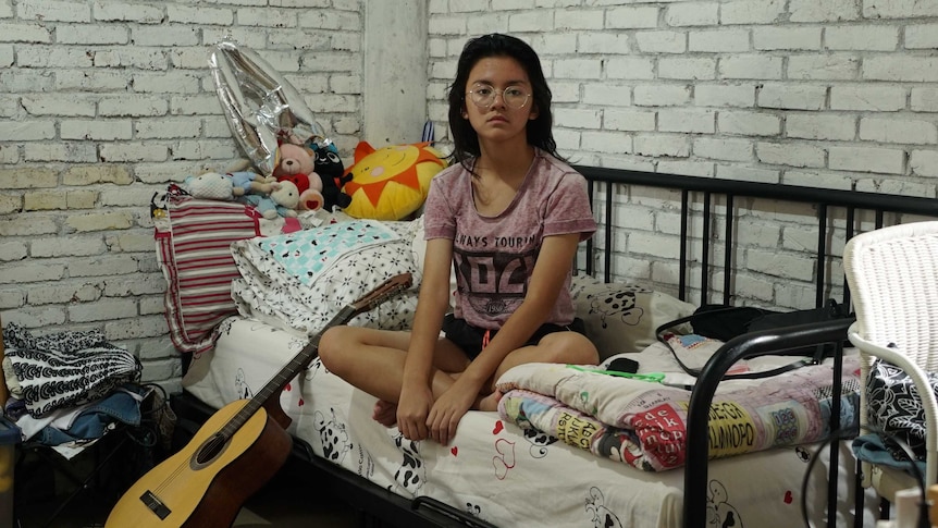 Fifteen-year-old Aida Ameera Alkaff sits in her bedroom in Bintaro, Indonesia.