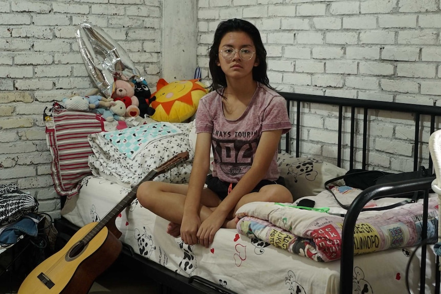 Fifteen-year-old Aida Ameera Alkaff sits in her bedroom in Bintaro, Indonesia.