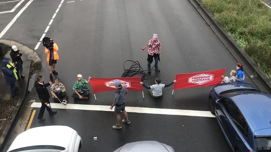 protesters holding banners on a road 