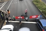 protesters holding banners on a road 