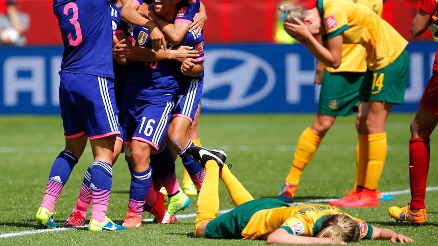 Japan celebrates Iwabuchi's game winner in the World Cup quarter-final against the Matildas