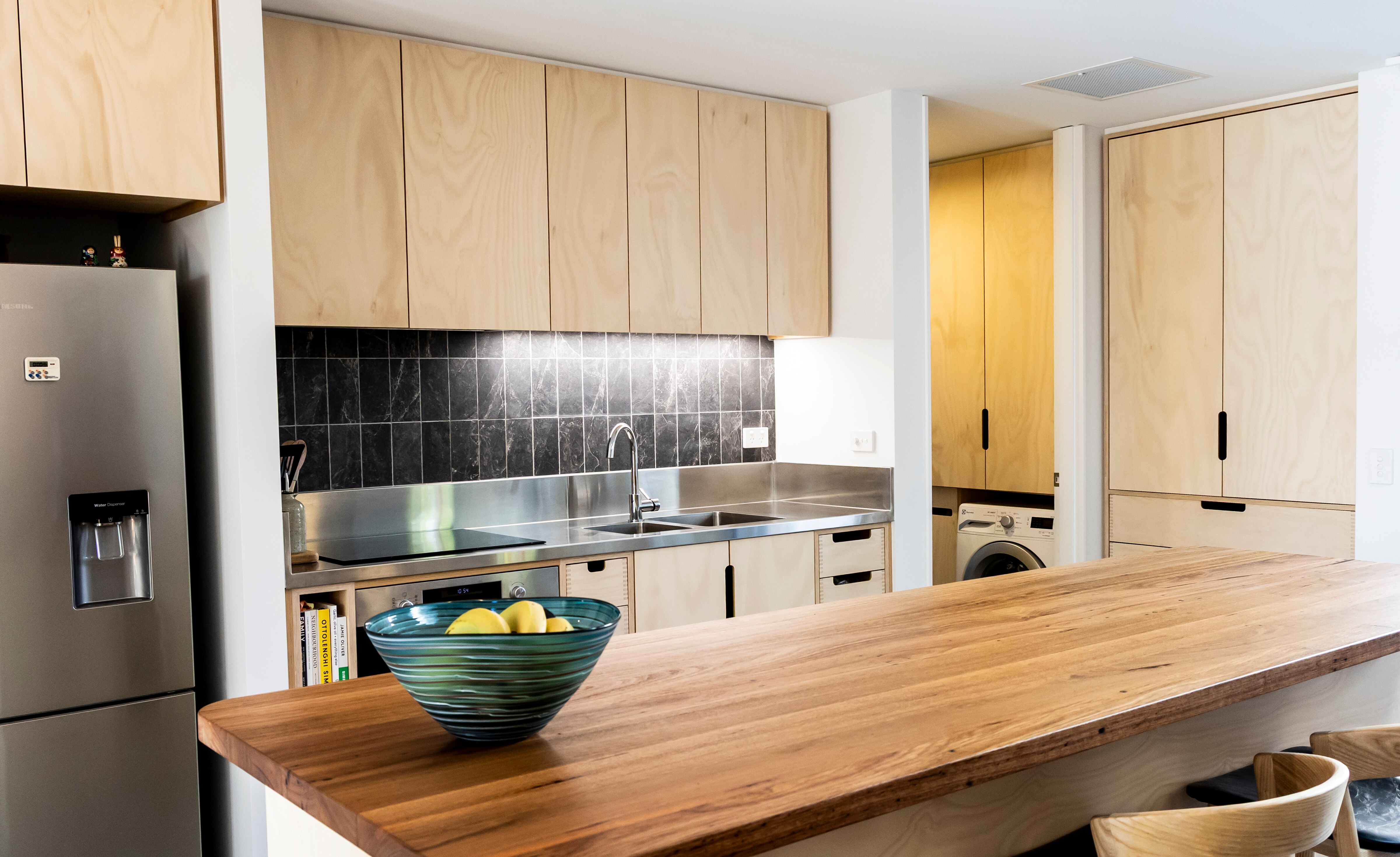 A new looking kitchen with timber cabinets.