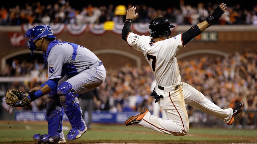 Gregor Blanco slides home to score for San Francisco against Kansas City in World Series game four.