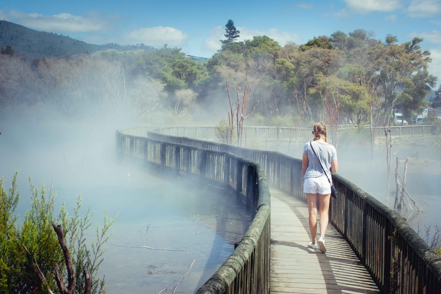 Rachel Bragg walking along a footpath by a body of water