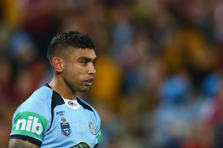 A man looks away from the camera during a State of Origin match
