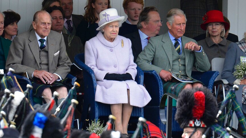 Prince Philip, Queen Elizabeth and Prince Charles watching pipe band in Scotland