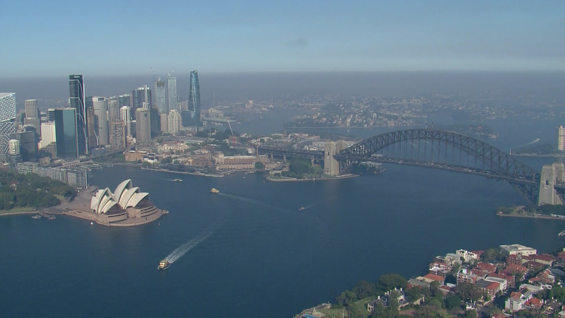 An aerial view of Sydney Harbour and the Harbour Bridge, amid smoke haze.