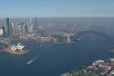 An aerial view of Sydney Harbour and the Harbour Bridge, amid smoke haze.