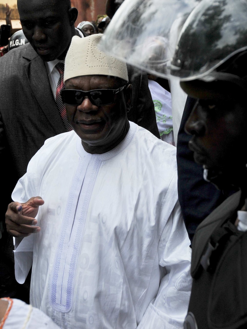 Mali's presidential candidate Ibrahim Boubacar Keita leaves the polling station after voting.