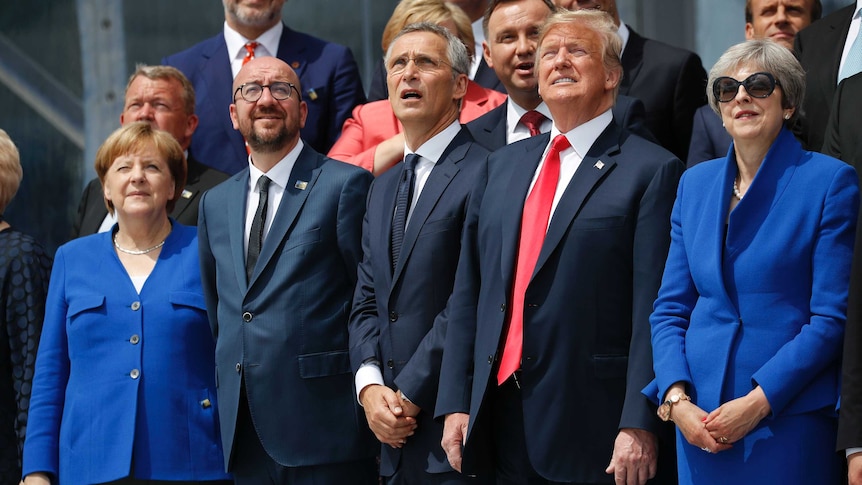 NATO leaders look up at a ceremonial fly-over