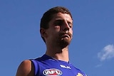 Tom Liberatore of the Bulldogs hobbles off with a knee injury