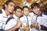 Four Indian athletes hold their gold medals after winning the table tennis competition at the 2006 Commonwealth Games.