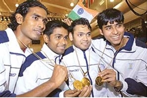 Four Indian athletes hold their gold medals after winning the table tennis competition at the 2006 Commonwealth Games.