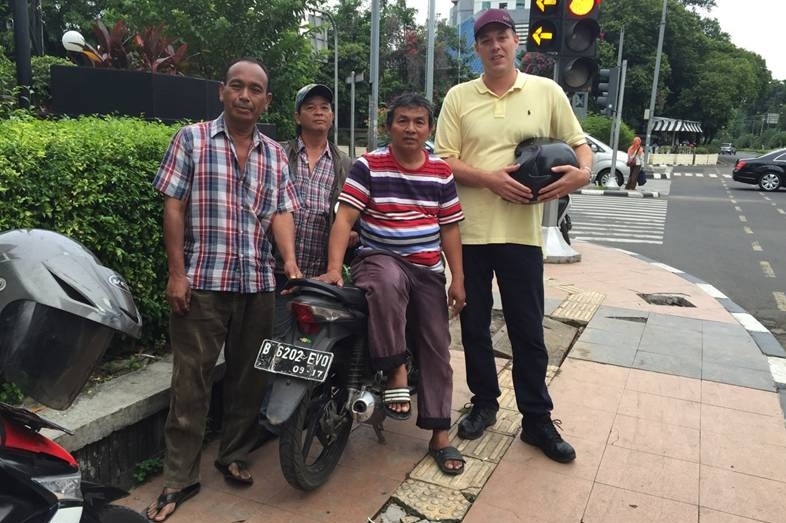 Adam Harvey with motorcycle drivers in Jakarta
