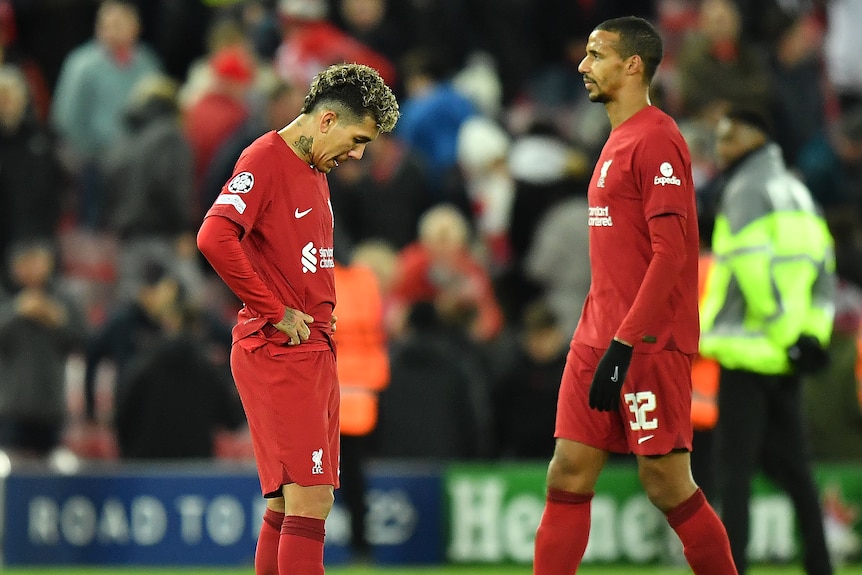 Liverpool's Roberto Firmino hangs his head and Joel Matip looks sad after a Champions League loss to Real Madrid.