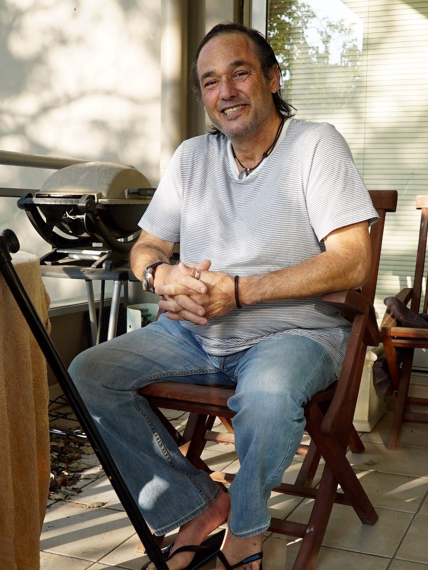 Palliative care patient Peter Morris sits on his balcony