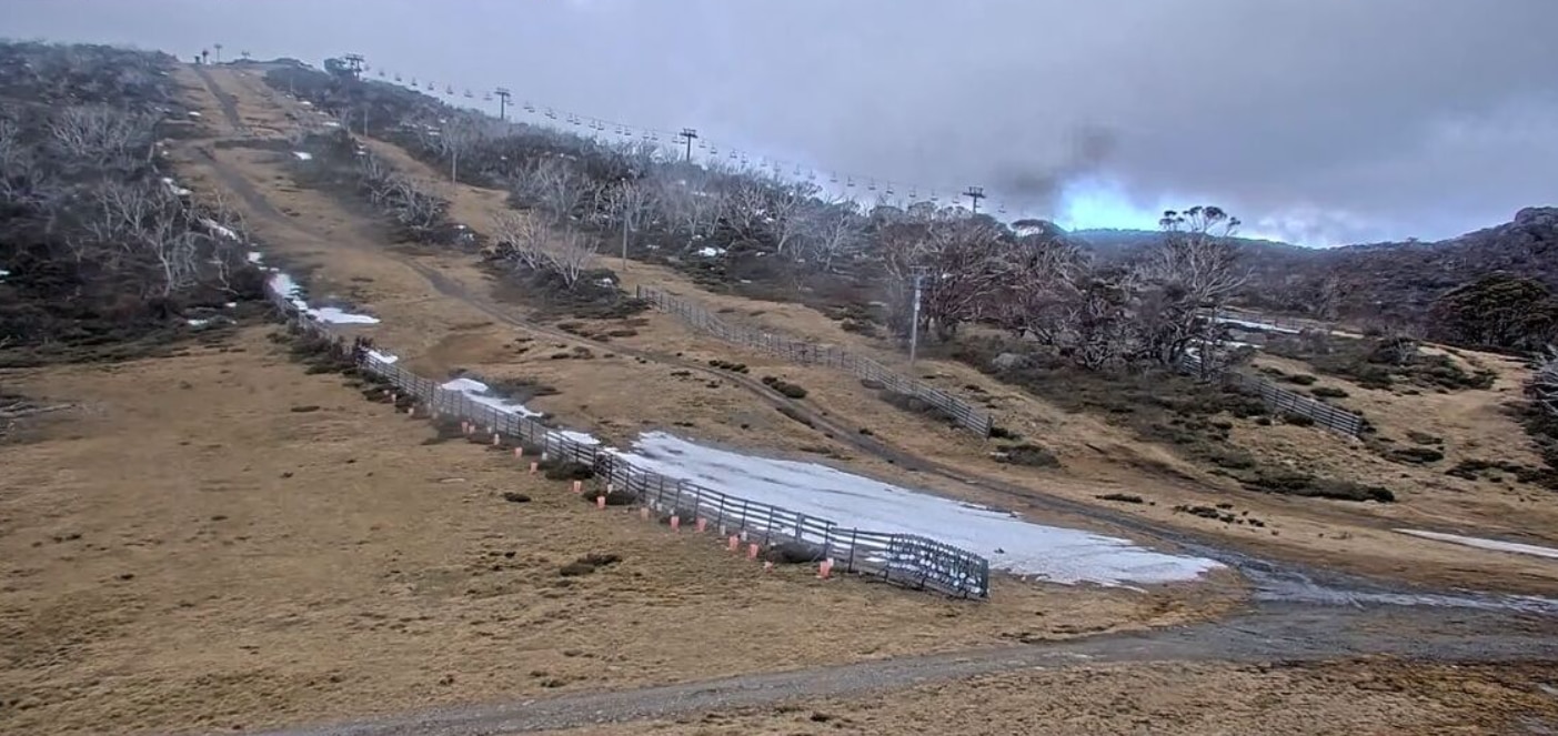 An alpine slope with little snow covering it at Perisher.