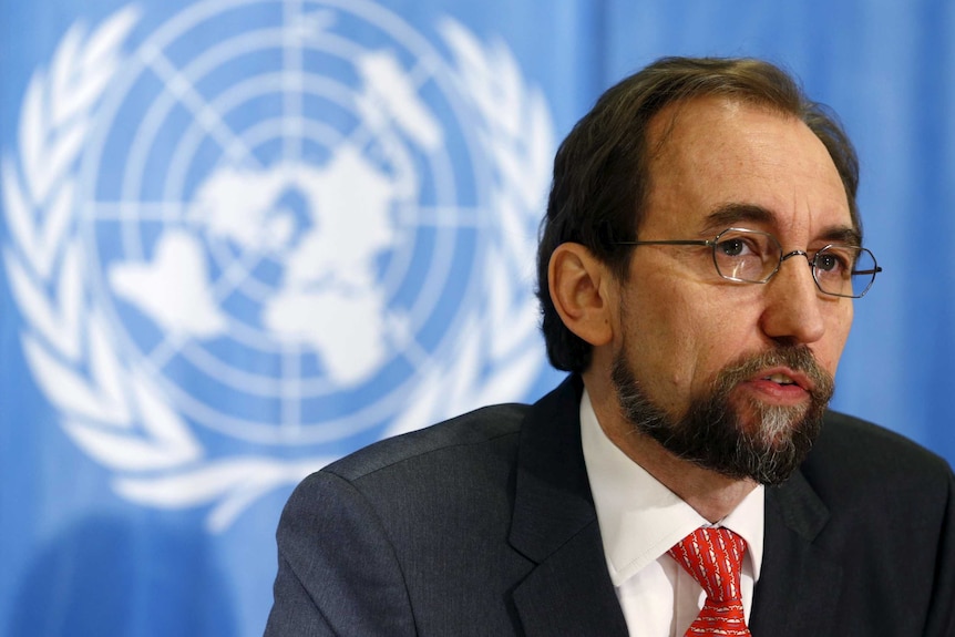 Zeid Ra'ad Al Hussein speaking in front of a United Nations logo backdrop