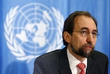 Zeid Ra'ad Al Hussein speaking in front of a United Nations logo backdrop