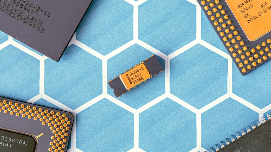 A small yellow and black computer chip on a light blue background.
