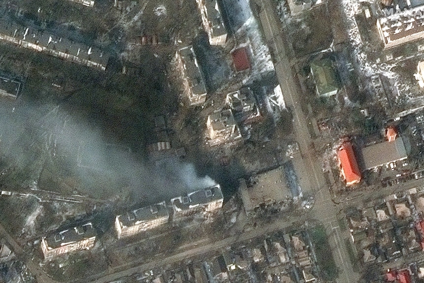 A satellite image of burning apartment buildings in Mariupol.