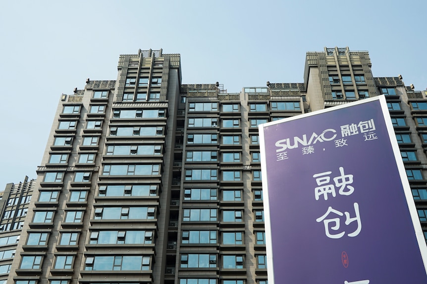 An advertisement of property developer Sunac China Holdings is seen at a residential complex in Shanghai, China