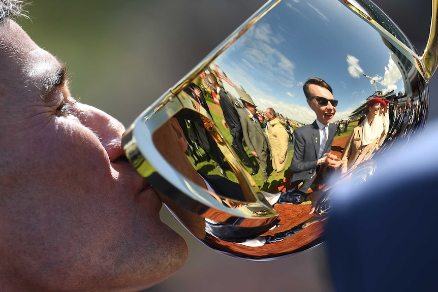 Close up of Jockey Corey Brown kissing the Melbourne Cup