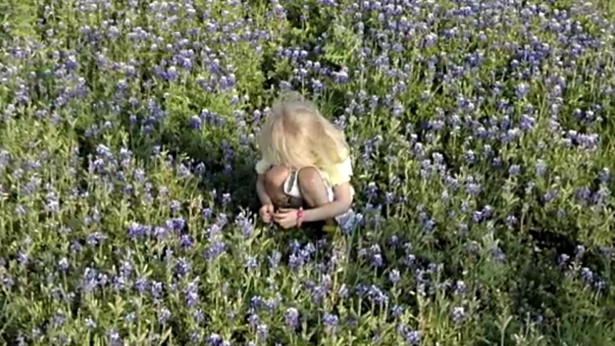 Sabrina Allen, who was abducted by her mother in 2002 at the age of four, plays in a field, date unknown.