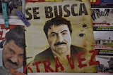 A poster with the face of Mexican drug lord Joaquin "El Chapo" Guzman, reading "Wanted, Again", is displayed at a newsstand in one Mexico City's major bus terminals on July 13, 2015