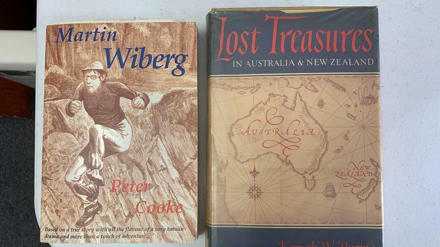 Two books on a desk. One is called "Martin Wiberg" the other is called "Lost Treasures in Australia and New Zealand".