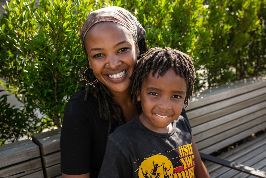 A mother and daughter smiling