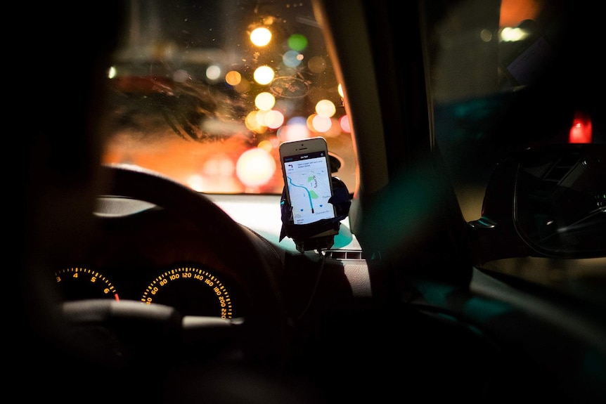 An Uber driver navigating using a mobile phone