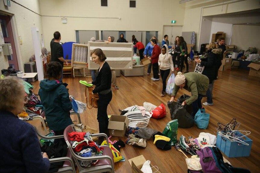Volunteers sort through donations at the Sunday Assembly Canberra's Refugee Housing Action Day