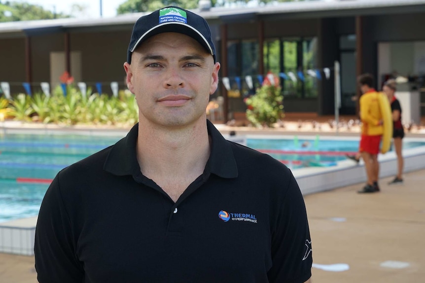 Matt Brearley stands by a pool.