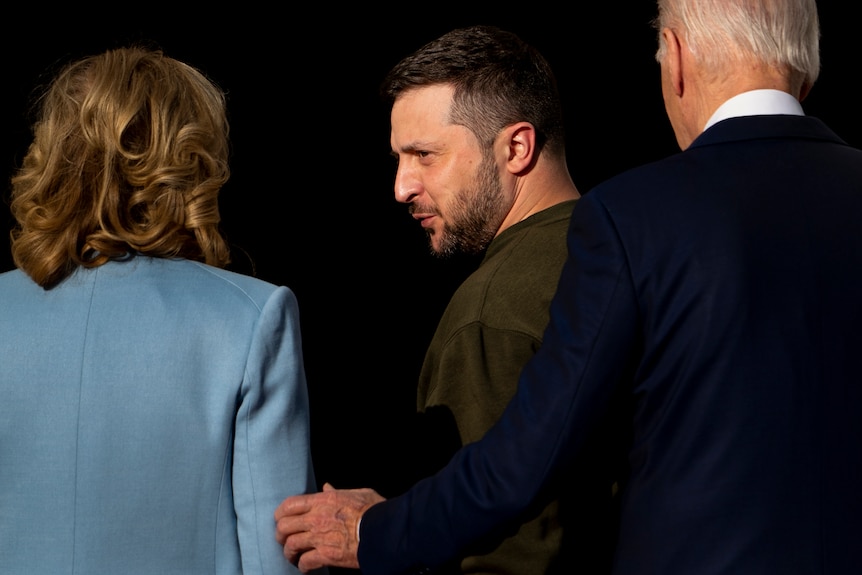 Side profile of Zelenskyy standing alongside Joe and Jill Biden