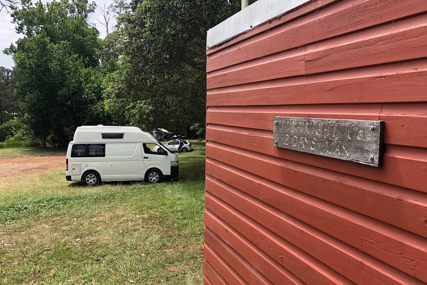 Vans parked in a free camping area near Bellingen in NSW where travellers can stay for a small donation.