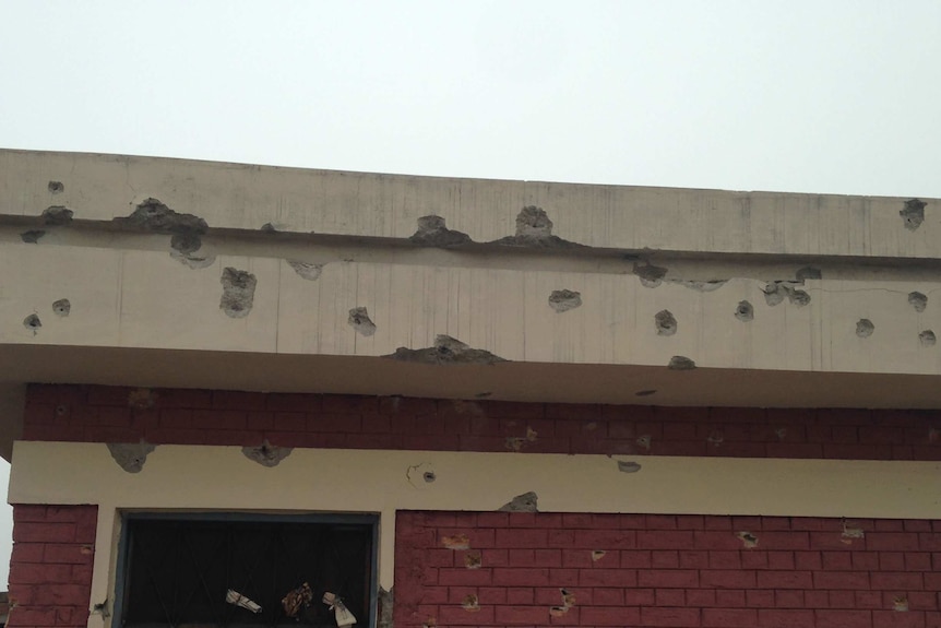 A bullet-riddled wall of the university's hostel.